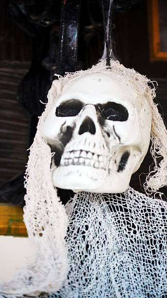 istock Skeleton skull Halloween decoration with white creepy fabric 2240235727