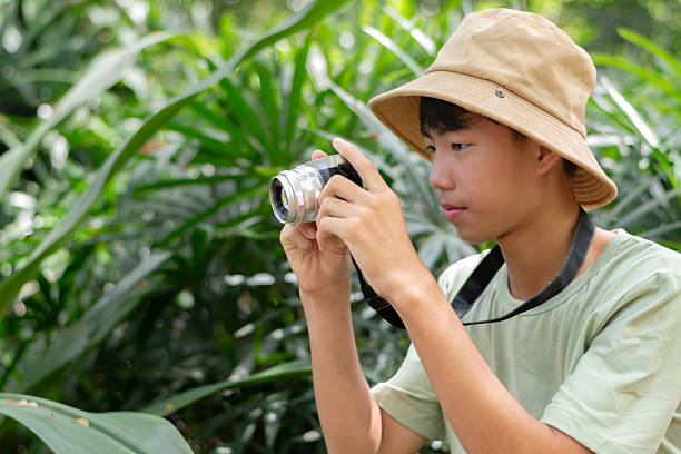 istock Asian teenaged boy with camera holding. 2240235861