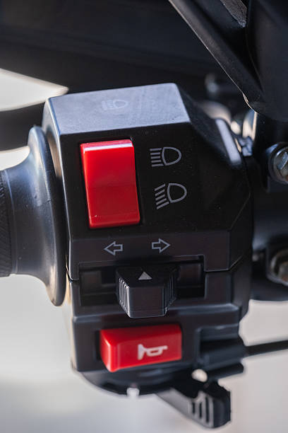 istock Closeup motorcycle control switch with red buttons for lights and indicators. Switch is mounted on handlebar, showcasing its functional design. 2240237034