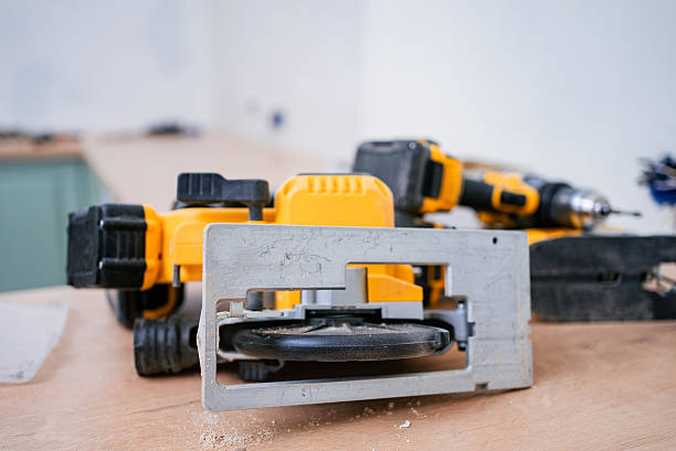 istock Professional circular saw and cordless drill resting on wooden workbench, surrounded by sawdust, highlighting active woodworking and home renovation efforts 2240237178