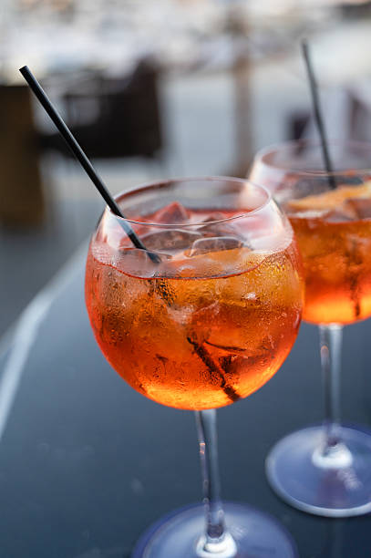 istock There are two glasses filled with orange liquid, each containing a straw 2240237507