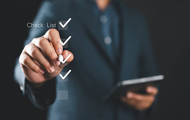 istock Businessman marking digital boxes. Checklist and task management concept. Productivity, workflow planning, time management, digital organization, and business execution visuals. 2240237534