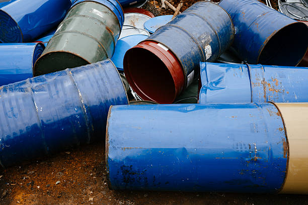 A pile of green metal cans stacked on top of each other. Scene is one of clutter and disorganization