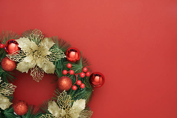 istock Christmas Wreath with Gold Accents on Red Background 2240242569