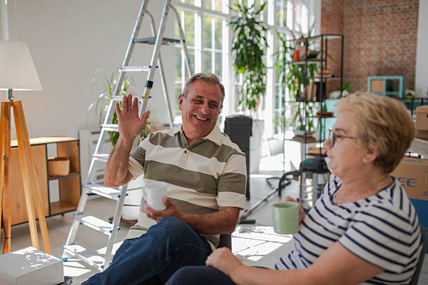 istock Smiling senior couple moving in, coffee break 2240242860