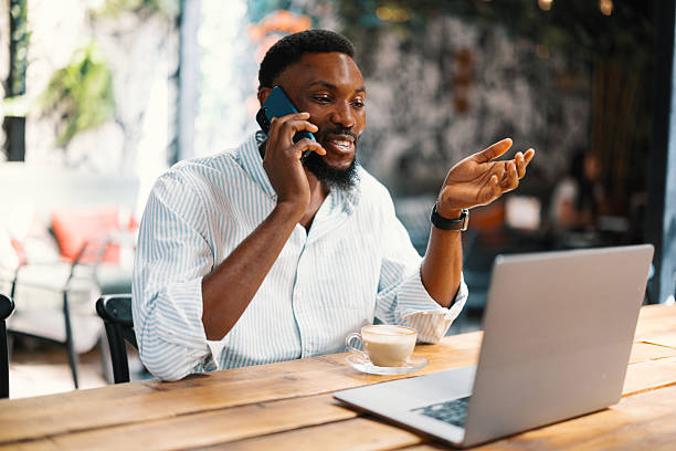 istock Man talking on the phone while sitting in a cafe 2240244020