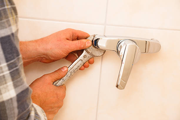 istock Plumber installs mixer tap for a shower 2240244270