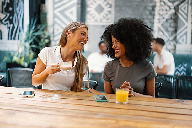 istock Happy and Smiling Female friends talking over coffee 2240244903