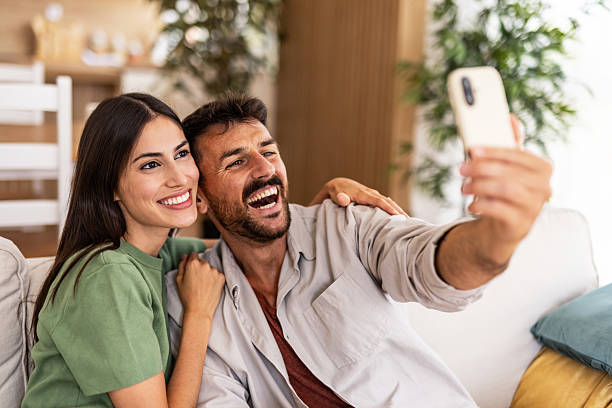 istock Happy couple taking selfie on couch at home 2240245794