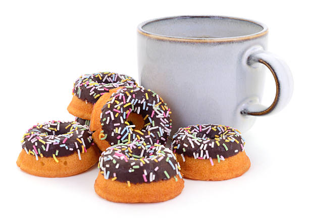 istock Cup of tea with mini chocolate donuts and colorful sprinkles 2240245815