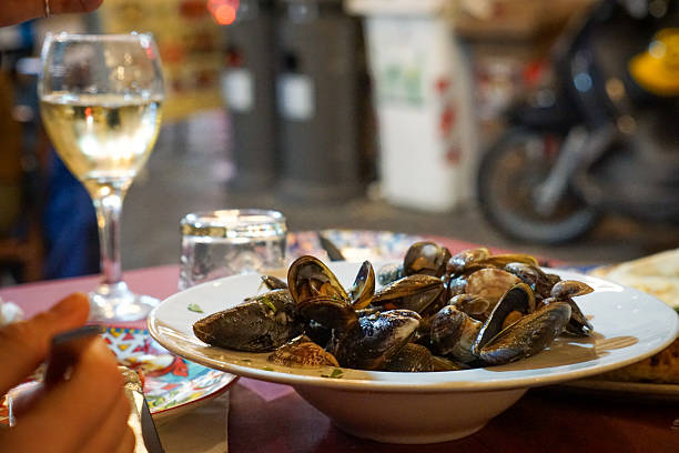 istock opened cooked mussels on a white plate in Italian restaurant 2240247069