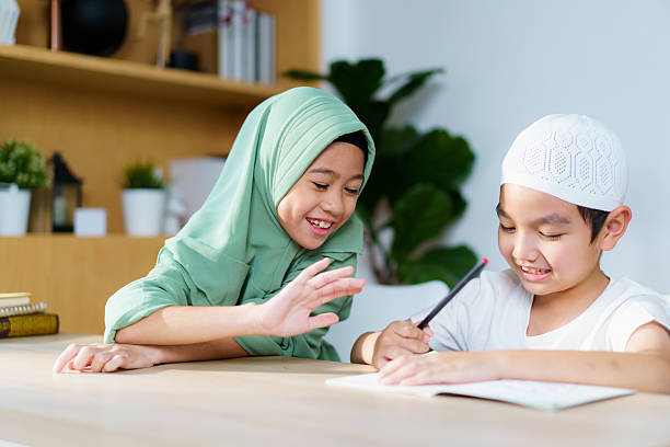 istock Muslim siblings study together, doing homework and reading in the study room. 2240249119