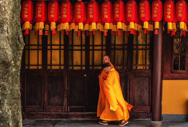 Changping District, China - An Asian Indian Tourist poses looking at the camera outside the Ming Tombs complex in the Changping district of the Beijing municipality in China. The person is wearing photochromatic lenses that automatically transform to sunglasses in the sunlight. The image was originally shot on 35 mm color film, scanned and restored in Adobe Lightroom Classic and Photoshop by the photographer.