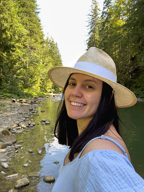istock Woman Enjoying Nature by a Forest River 2240251608