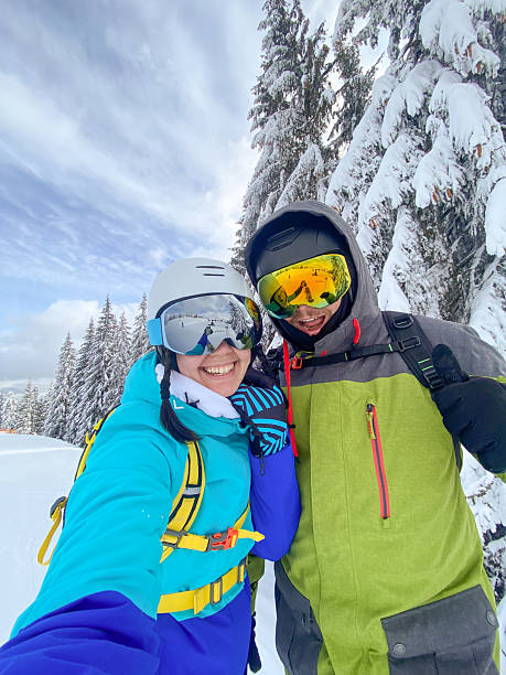 istock Couple Taking Selfie on Snowy Mountain 2240252406