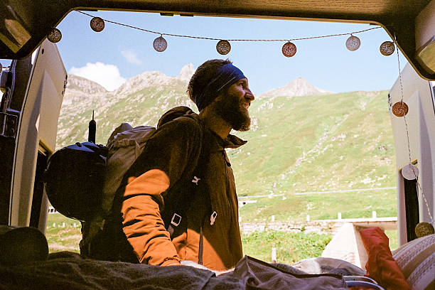 istock Mountain climber at the back of his van 2240255182