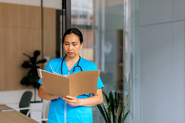 istock Female nurse analysing document at hospital 2240256050