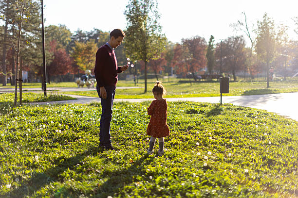 istock Father and daughter spending time together in park 2240257122