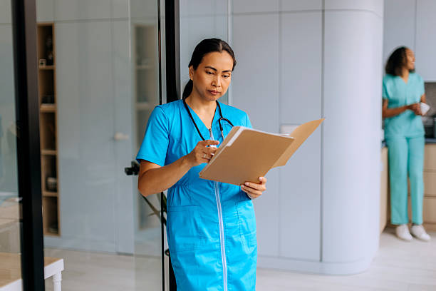 istock Female nurse analysing document at hospital 2240257724