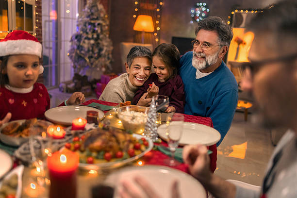 istock Multi generational family celebrating Christmas with festive dinner 2240258643