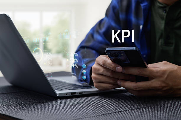 istock Businessman Analyzing KPI Performance with Laptop and Smartphone 2240259092