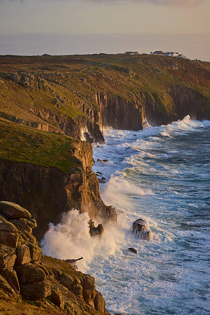 Land's End coastline, Cornwall, England, UK during a stormy sunset