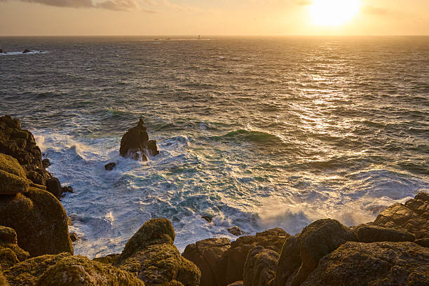 Lands End in Cornwall UK. Long exposure showing the rocky coast and the lighthouse