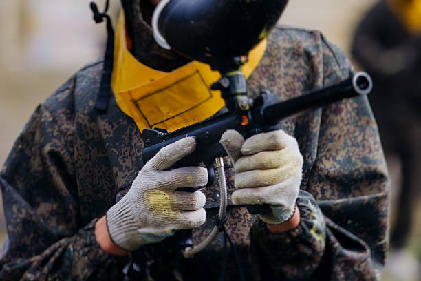 Close up of paintball players with paint on  protective mask