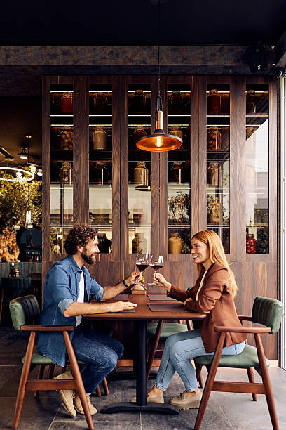 istock Couple Enjoying Wine at a Stylish Restaurant Setting Indoors 2240261784