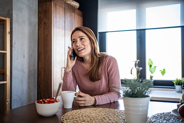 istock Woman talking on phone during breakfast 2240263154