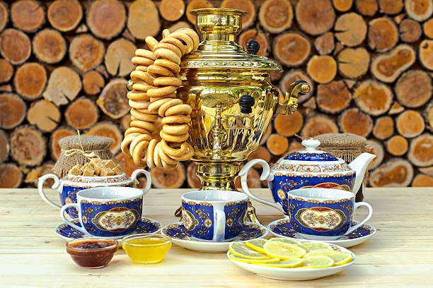 Golden samovar on the table with tea set in russian style
