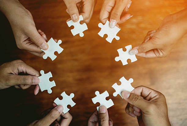 istock Jigsaw puzzles combine teamwork, unity and teamwork, achieving success in work and business growth. 2240263814