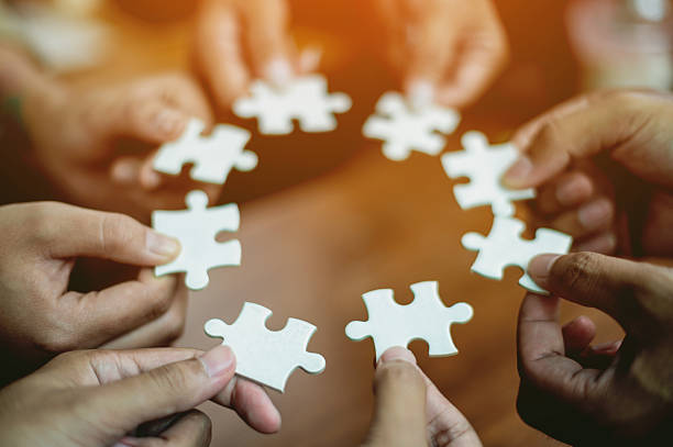 istock Jigsaw puzzles combine teamwork, unity and teamwork, achieving success in work and business growth. 2240263815