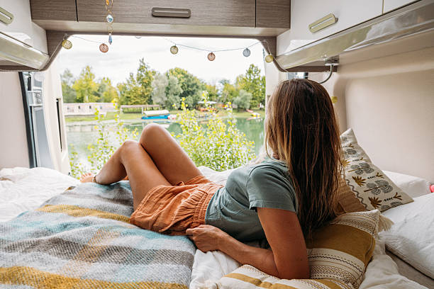 istock Woman Relaxing Inside Van Overlooking Lake 2240264296