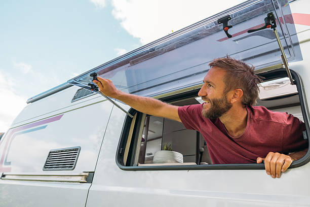 istock Man Opening Camper Van Window Outdoors 2240264713