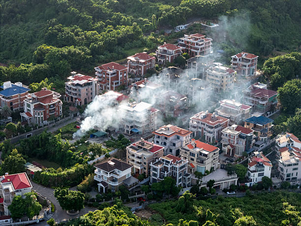 istock Smoke Rising from Residential Buildings Amidst Greenery 2240265024