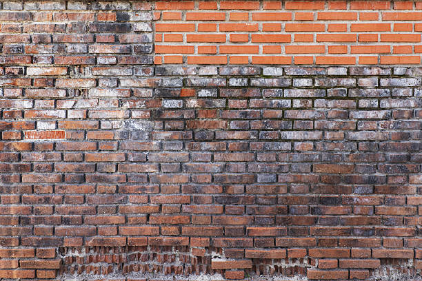 istock A wall of brown bricks of different ages and large chips. Vector bricks texture background 2240266377