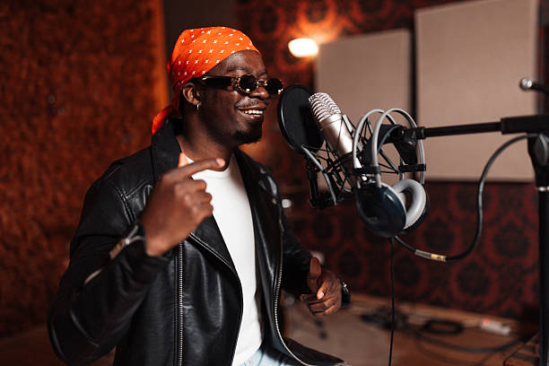 istock Confident music artist performing in recording studio 2240267102