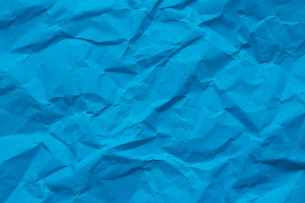 istock Macro crumpled blue paper background,Abstract blue paper texture as background. Texture of slightly crumpled craft paper. Paper background. Recycled blue paper backdrop in close up. blue Textures. Wallpaper. 2240267125