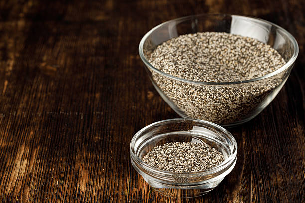 istock Glass bowl with chia seeds on wooden table 2240267716