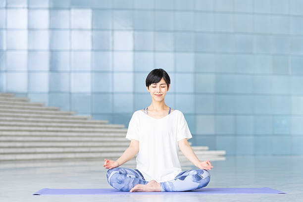 istock Young woman practicing yoga in a studio 2240267874