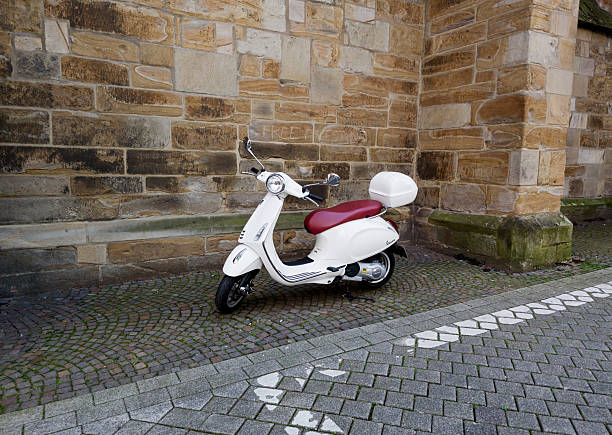 Dortmund, Germany - October 10, 2025 - Vintage white Vespa scooter parked in city street