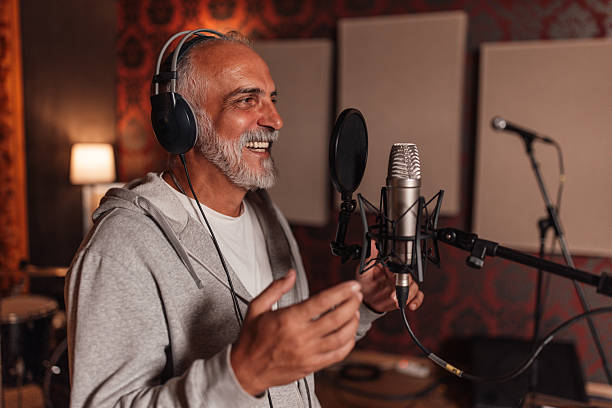 istock Elderly man enthusiastically singing in the studio 2240269257