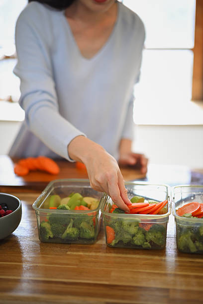 Closeup attractive woman arranging her dividing food into meals