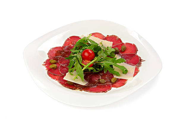 istock Beef carpaccio appetizer with ruccola isolated on white 2240270157