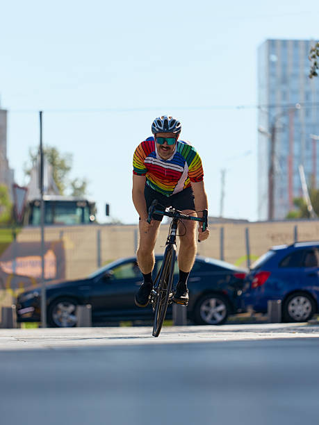 istock Cyclist racing forward on city road with strong focus 2240270977