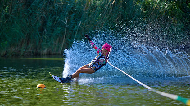 Mother and daughter have fun running in water with splashing. The state of happiness, freedom and independence. Strengthening parent child relationships, physical and psychological health in family.