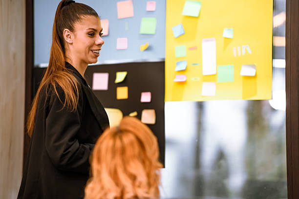 istock Engaging team discussion in a modern workspace with sticky notes on the wall 2240272526