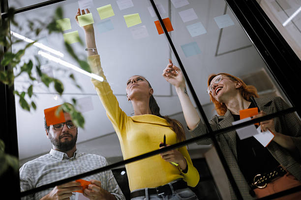 istock Team brainstorming session with sticky notes in a modern office environment during the afternoon 2240272577