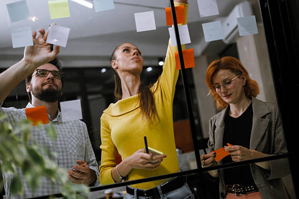 istock Creative team brainstorming strategies during a collaborative session in a modern office space with colorful sticky notes 2240272604